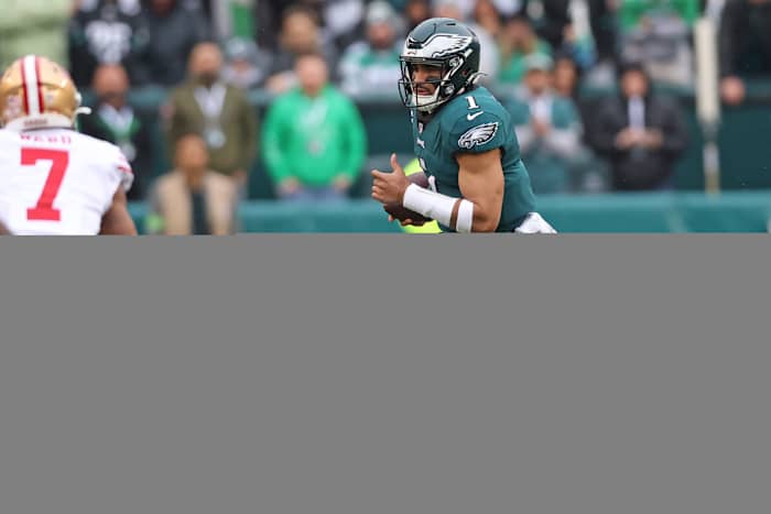Eagles quarterback Jalen Hurts runs with the football against the 49ers.
